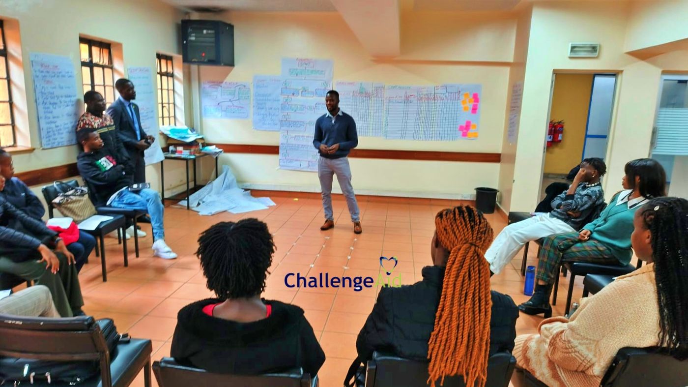 ChallengeAid training workshop with a facilitator presenting to a seated group